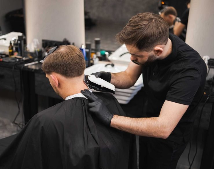 male-hairdresser-making-a-haircut-for-a-young-man-2022-02-17-20-02-40-utc-2.jpg