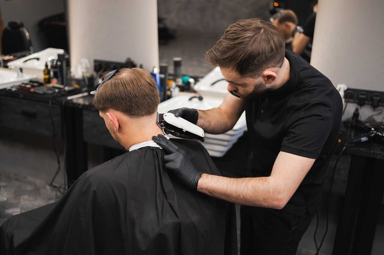 male-hairdresser-making-a-haircut-for-a-young-man-2022-02-17-20-02-40-utc-2.jpg
